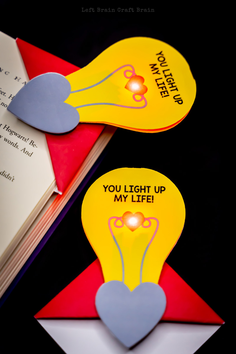 two completed light up valentine corner bookmarks on a book
