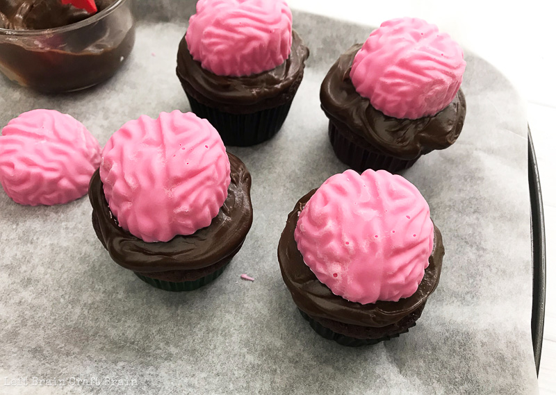 top the cupcakes with the candy brain