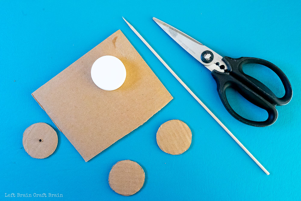 cut out wheels out of cardboard and poke with a skewer