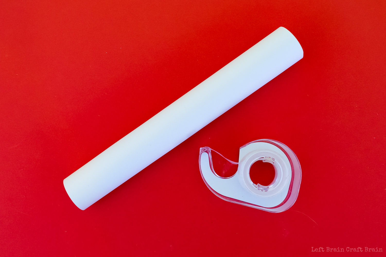 roll of cardstock on red background with tape dispenser