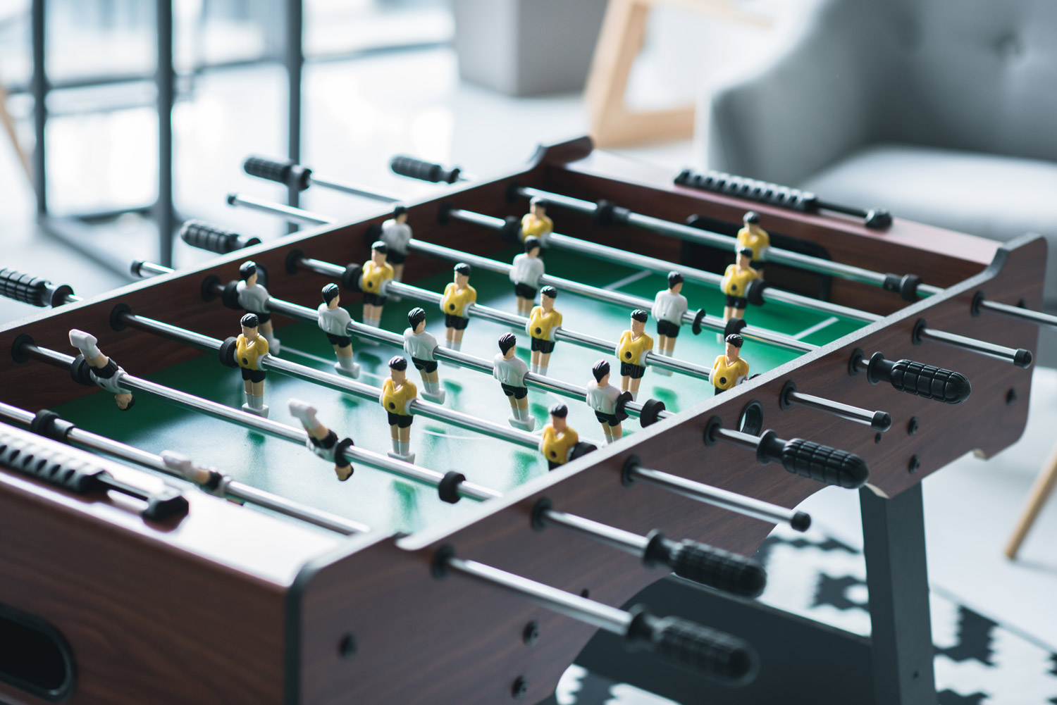 foosball table with yellow and white jersey players